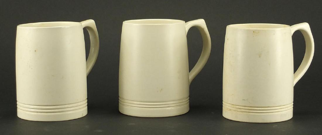Three Wedgwood mugs designed by Keith Murray, each 12.5cm high: Three Wedgwood mugs designed by Keith Murray, each 12.5cm high