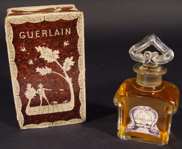 Baccarat Guerlain glass scent bottle and stopper w: Baccarat Guerlain glass scent bottle and stopper with original paper label 'Shalimar' housed in a Guerlain box, etched mark to the base, 14cm high