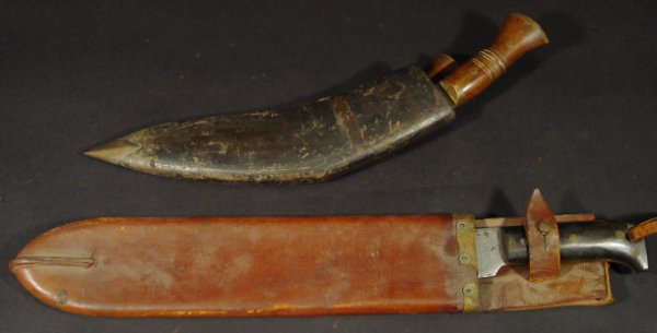 Military interest steel bladed machete and leather: Military interest steel bladed machete and leather scabbard, stamped 'USA No1250 1940' to the blade, together with a military kukri knife and smaller blade stamped 'Military supply syndicate' to the b