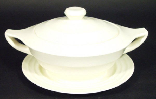Wedgwood Keith Murray Moonstone tureen and cover o: Wedgwood Keith Murray Moonstone tureen and cover on stand decorated in a white glaze, printed factory marks to the bases, 30cm in length