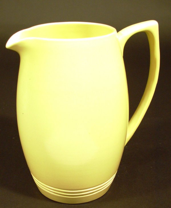 Wedgwood Keith Murray jug decorated in matt straw: Wedgwood Keith Murray jug decorated in matt straw glaze, printed factory mark and full signature to the base, 21cm high