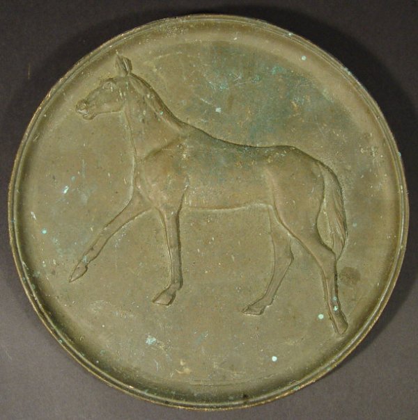 Circular bronze wall plaque cast in relief with a