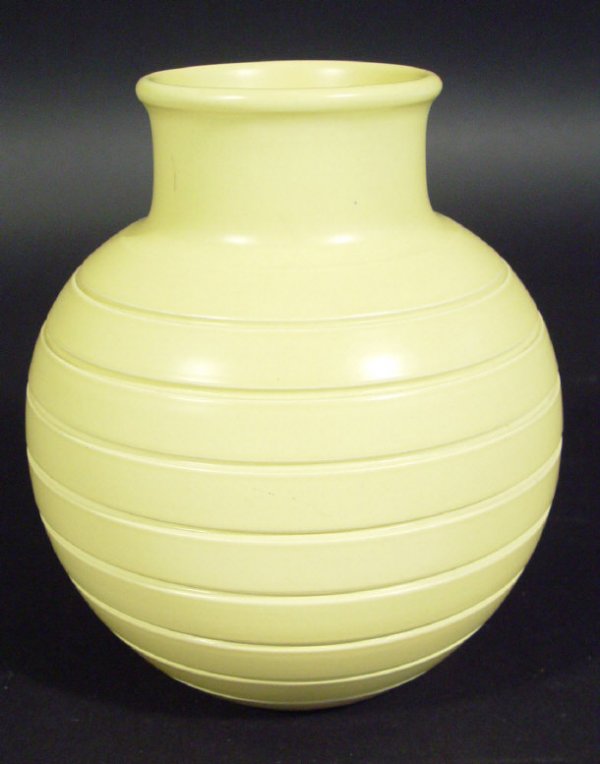 Wedgwood Keith Murray football vase decorated in a: Wedgwood Keith Murray football vase decorated in a matt straw glaze, printed factory mark and initials to the base, 15cm high