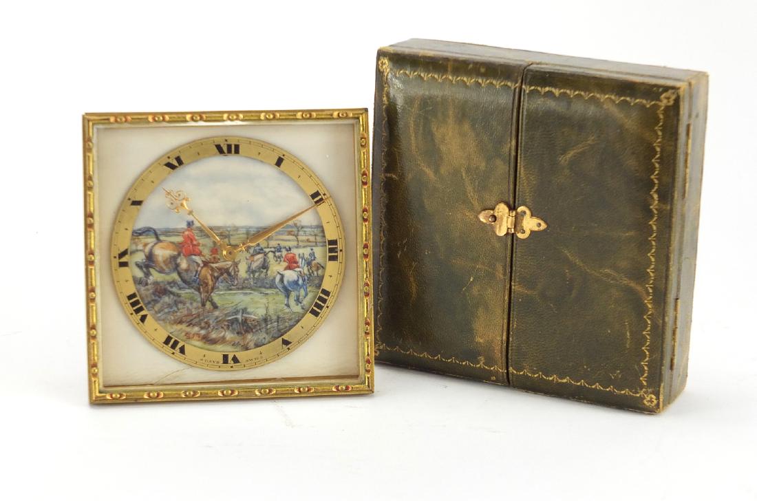 Art Deco gilt metal strut clock with eight day Swiss: Art Deco gilt metal strut clock with eight day Swiss movement, retailed by Swaine & Adeney, the ivory dial hand painted with a hunting scene signed S J T, with fitted case, 10.5cm W