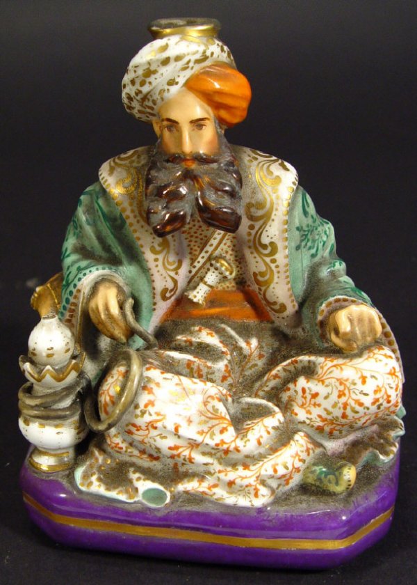 19th century continental porcelain spill vase mode: 19th century continental porcelain spill vase modelled as a Turk with hand painted and gilded decoration, marked 'JP' to the base, 13cm high