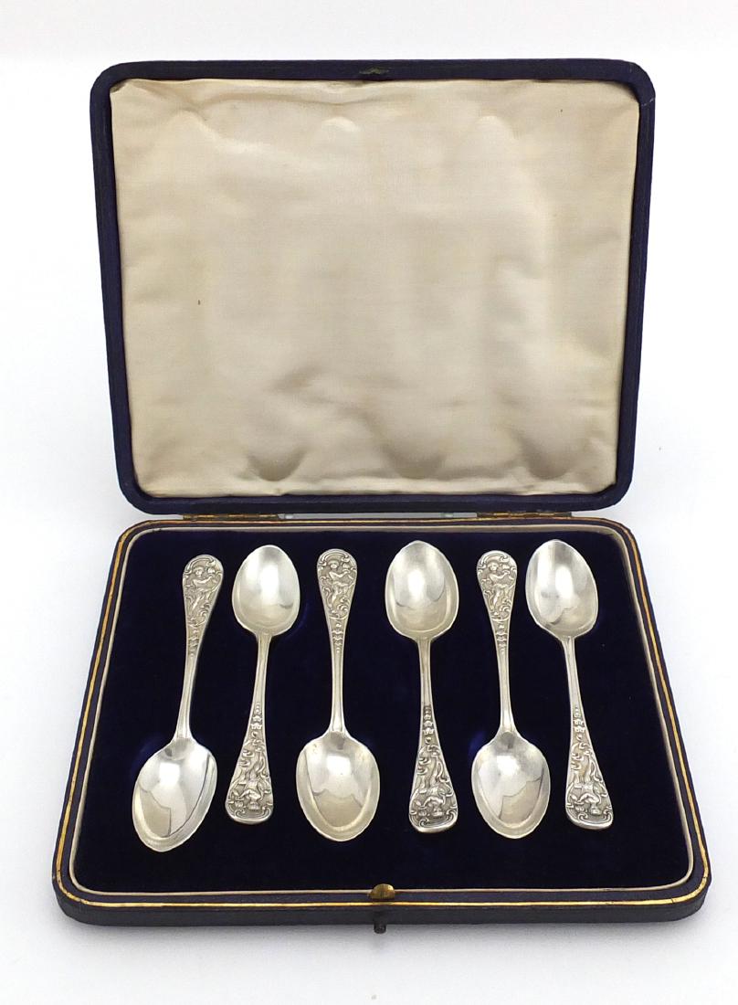 Set of six Victorian silver teaspoons with young boy: Set of six Victorian silver teaspoons with young boy amongst flowers terminals, by William Comyns, London 1898, housed in a velvet and silk lined tooled leather box