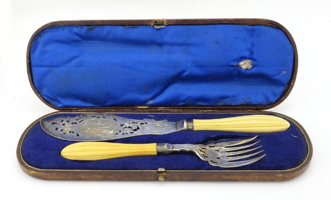 Pair of Victorian fish servers, with ivory handles and: Pair of Victorian fish servers, with ivory handles and silver plated blades engraved with a coastal scene, housed in a velvet and silk lined tooled leather box, the slice 32cm in length