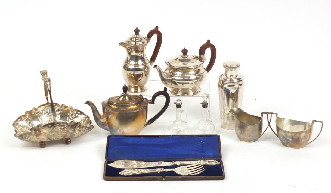 Silver plate including part silver plated tea set,: Silver plate including part silver plated tea set, Garrard & Co teapot and coffee pot, cocktail shaker, silver mounted oil and vinegar bottles with stoppers and a pair of engraved fish servers, housed
