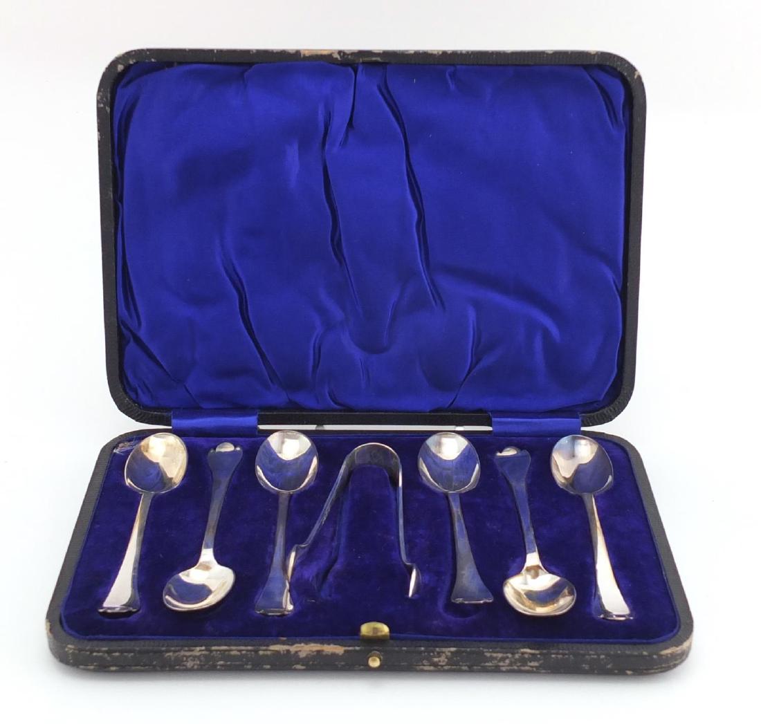 Set of six Arts & Crafts silver teaspoons and sugar: Set of six Arts & Crafts silver teaspoons and sugar tongs, by Isaac Ellis & Sons Sheffield 1908, housed in a velvet and silk lined tooled leather box, the spoons 11.5cm in length, approximate weight 8