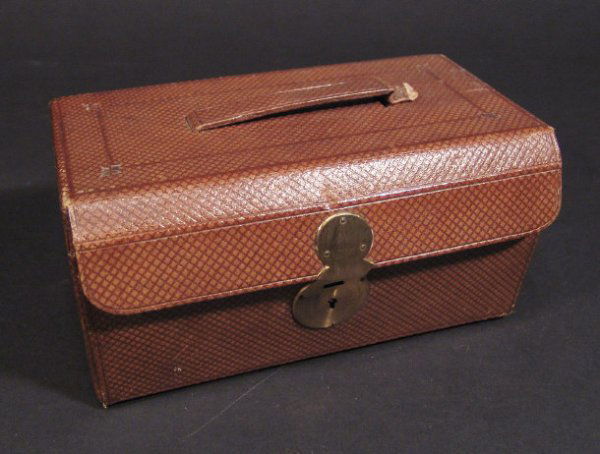Victorian leather travelling vanity case, the velv: Victorian leather travelling vanity case, the velvet lined interior fitted with bone handles, brushes, nail tools and boxes, cut glass scent bottle etc, 22cm in length