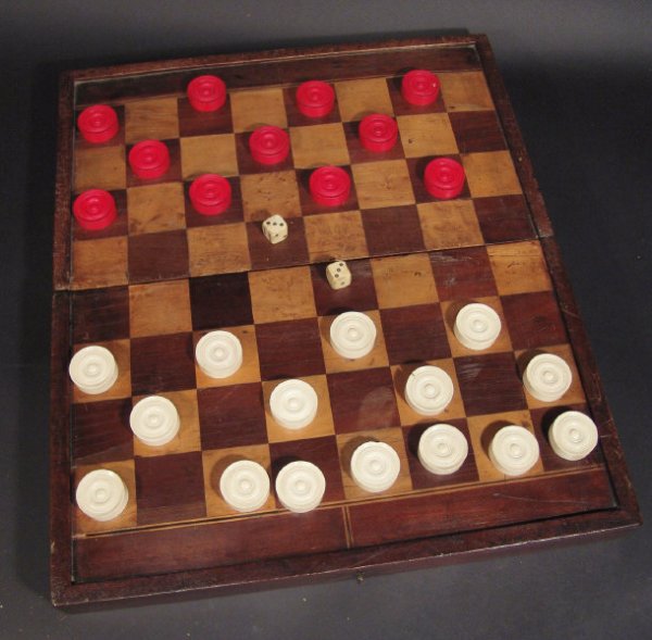 Early 19th century mahogany and walnut inlaid game: Early 19th century mahogany and walnut inlaid games box with bone draughtsmen, dice and a leather jack shaker, the box 45cm in length
