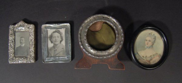 Two rectangular silver easel photo frames, one emb: Two rectangular silver easel photo frames, one embossed with flowers, a circular silver easel photo frame and an oval portrait miniature onto ivory of a woman clutching a fan in an ebonised frame, var