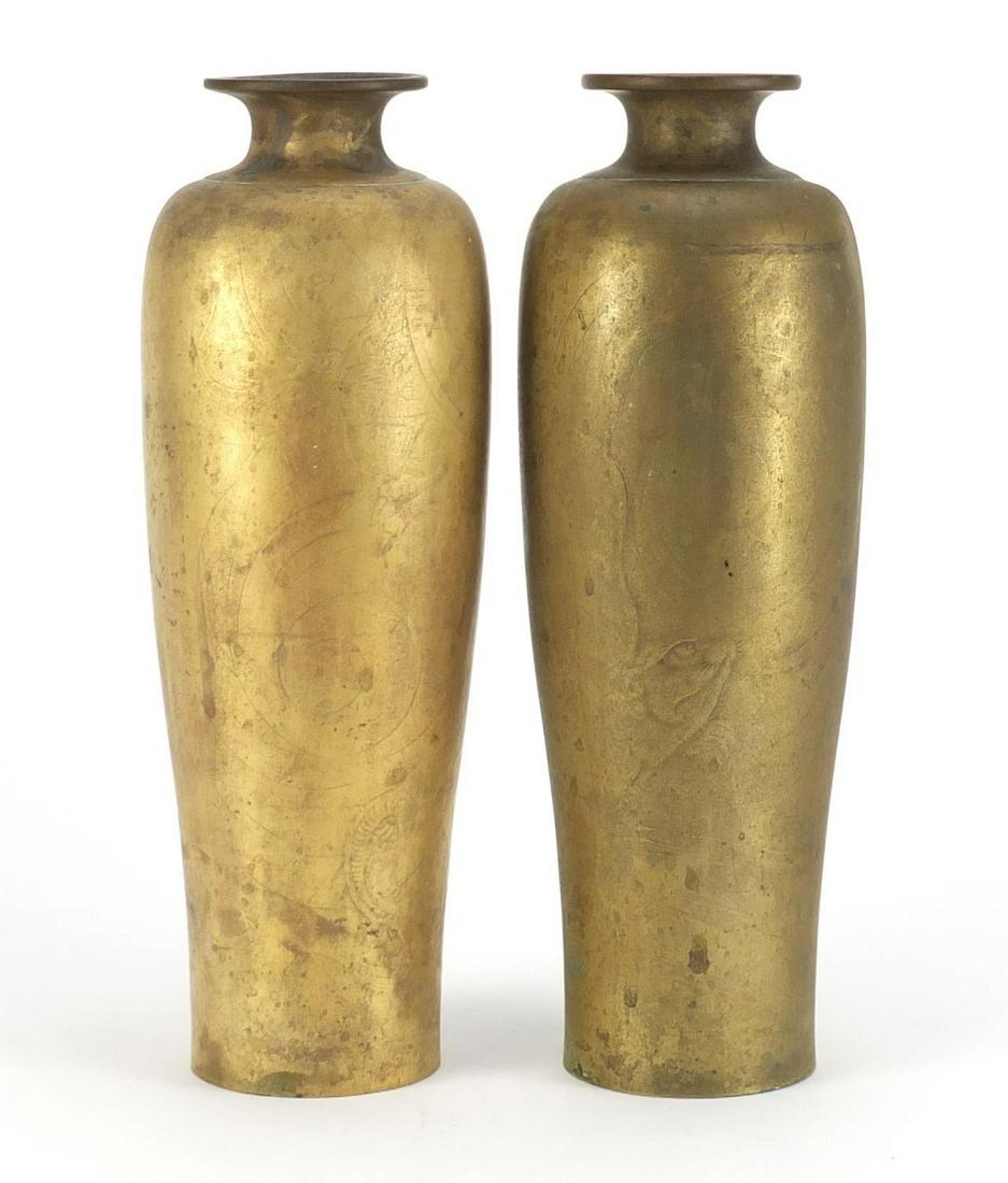 Pair of Chinese bronze vases, decorated in low relief: Pair of Chinese bronze vases, decorated in low relief with a dragon and mythical sea creature, each 27cm high
