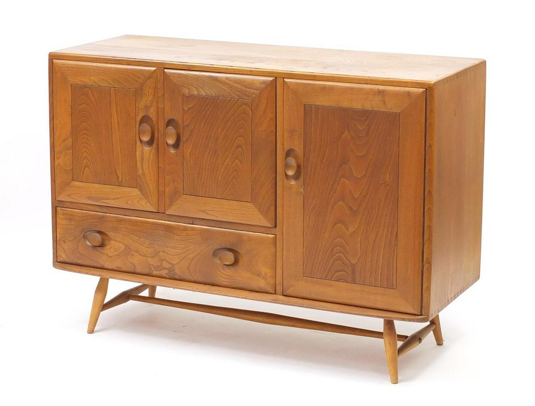 Ercol Windsor light elm sideboard fitted with three: Ercol Windsor light elm sideboard fitted with three cupboard doors and a drawer, 82cm H x 115cm W x 44cm D