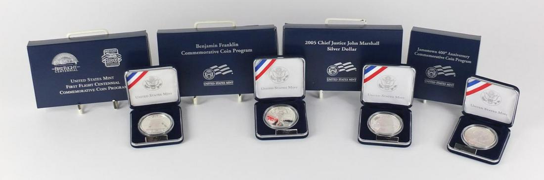 Four United States Mint silver proof dollars with cases: Four United States Mint silver proof dollars with cases and boxes comprising First Flight Centennial, 2005 Chief Justice John Marshall, Benjamin Franklin and Jamestown 400th Anniversary