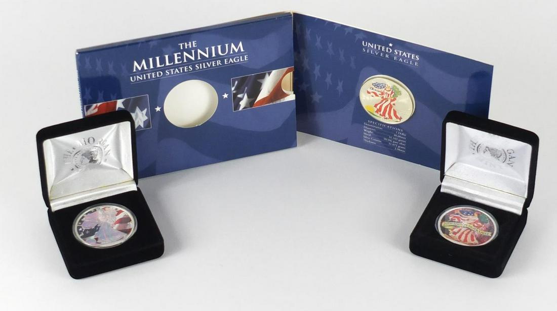 Three United States coloured silver dollars, two with: Three United States coloured silver dollars, two with cases comprising dates 2000, 2003 and 2005