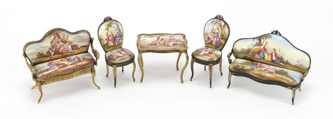 19th century enamel dolls house furniture with gilt: 19th century enamel dolls house furniture with gilt metal mounts, probably french, comprising two settees and a table with two chairs, each hand painted with courting couples, the largest 9.5cm wide