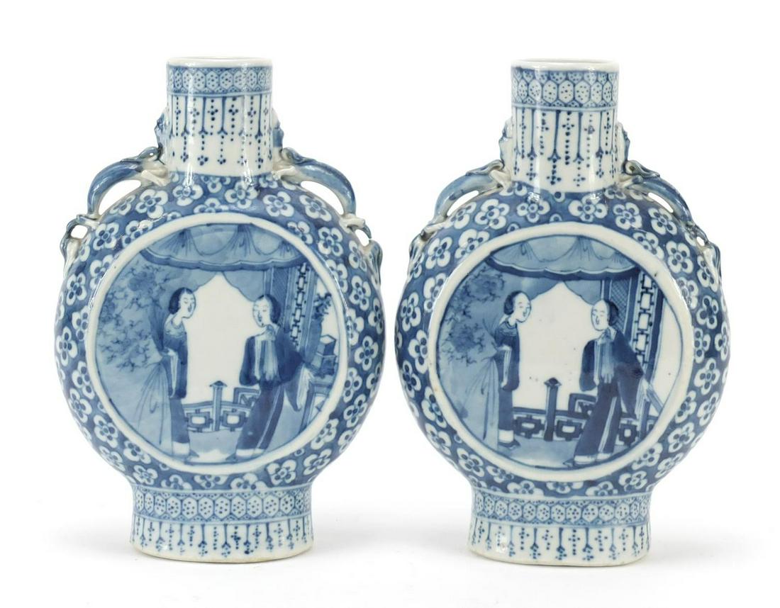 Pair of Chinese blue and white porcelain moon flasks: Pair of Chinese blue and white porcelain moon flasks with twin handles, each hand painted with panels of figures onto a prunus ground, each 21.5cm high