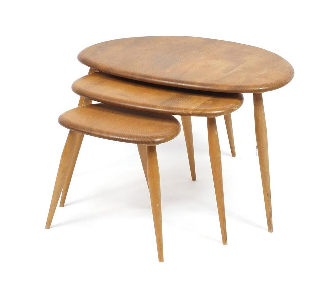 Nest of three Ercol elm pebble tables, the larlgest: Nest of three Ercol elm pebble tables, the larlgest 40cm high x 65cm wide x 44cm deep