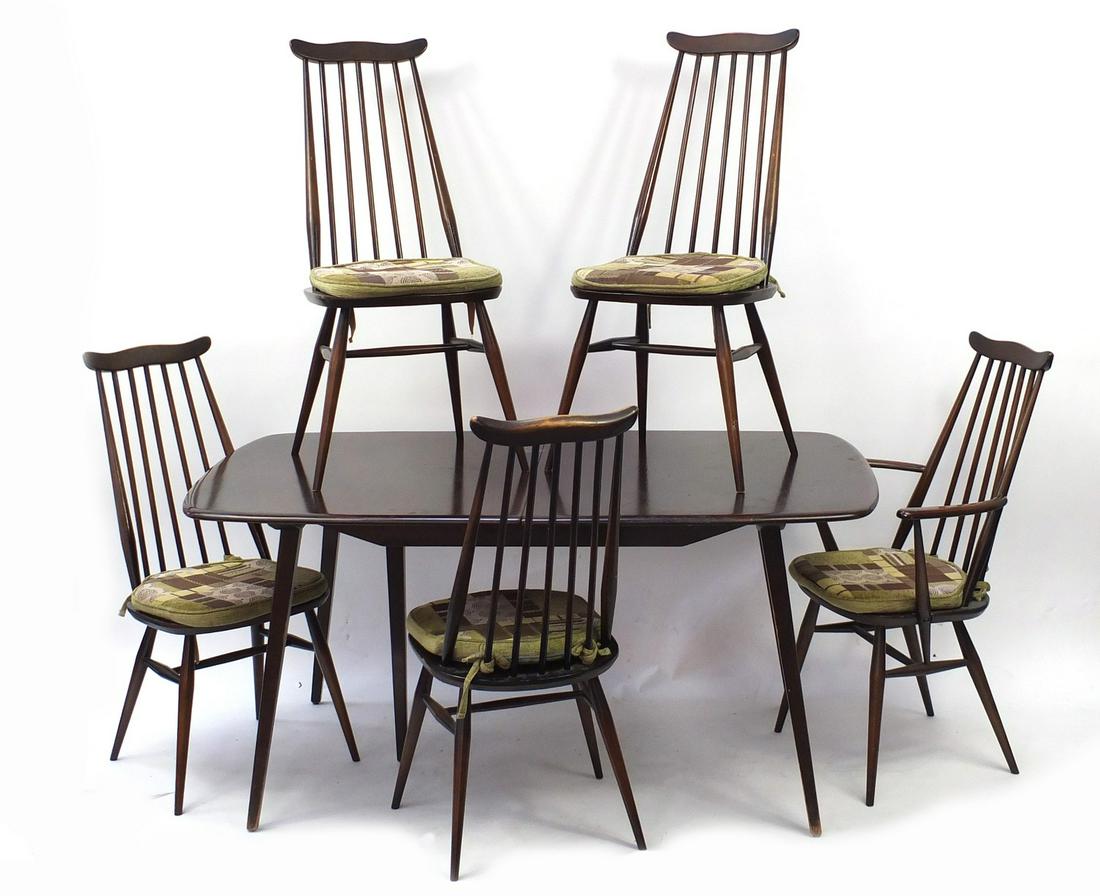 Ercol elm extending dining table with five stick back: Ercol elm extending dining table with five stick back chairs and leaf, the table 71cm H x 152cm W x 91cm D when closed, the chairs 97cm high