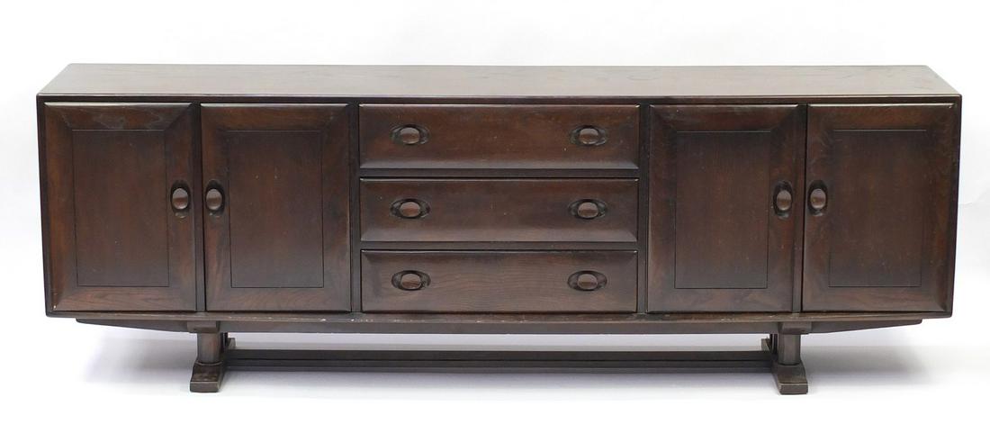 Ercol elm sideboard fitted with three drawers and four: Ercol elm sideboard fitted with three drawers and four cupboard doors, 74cm H x 218cm W x 43cm D