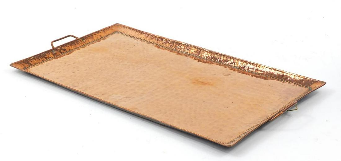 John Pearson, Arts & Crafts rectangular planished: John Pearson, Arts & Crafts rectangular planished copper tray with twin handles, impressed marks to the reverse, 63.5cm wide