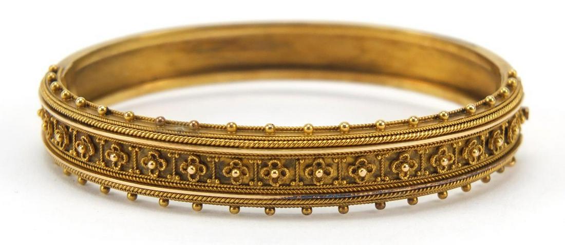 Victorian unmarked gold hinged bangle, (tests as 15ct: Victorian unmarked gold hinged bangle, (tests as 15ct gold) 6cm wide, 17.2g, housed in a T Wagner Ltd tooled leather box