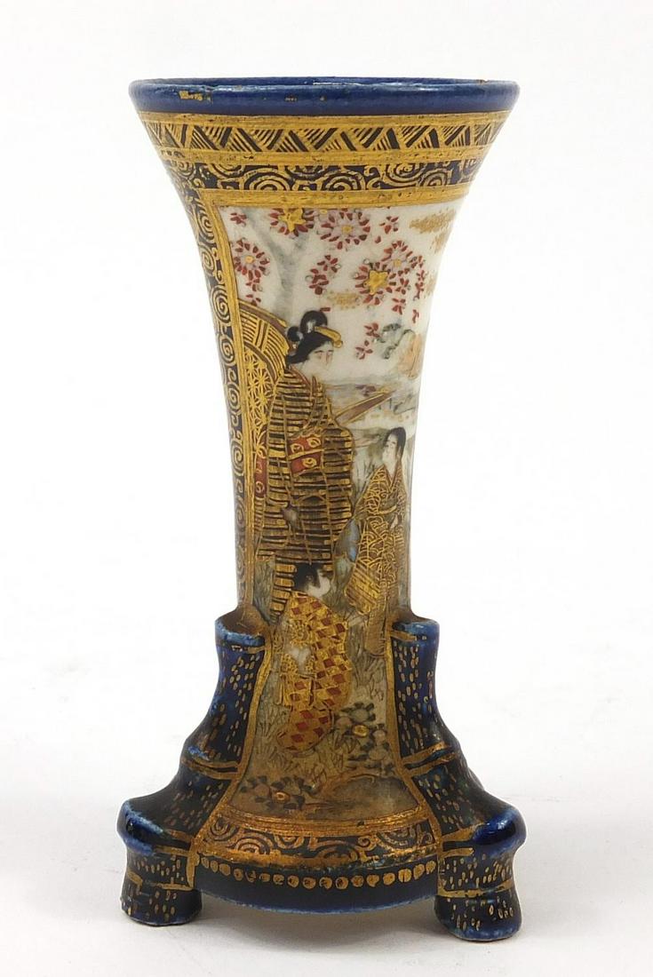Japanese Satsuma pottery vase on three faux bamboo: Japanese Satsuma pottery vase on three faux bamboo feet, hand painted and gilded with figures onto a cobalt blue ground, painted and impressed marks to the base, 9cm high