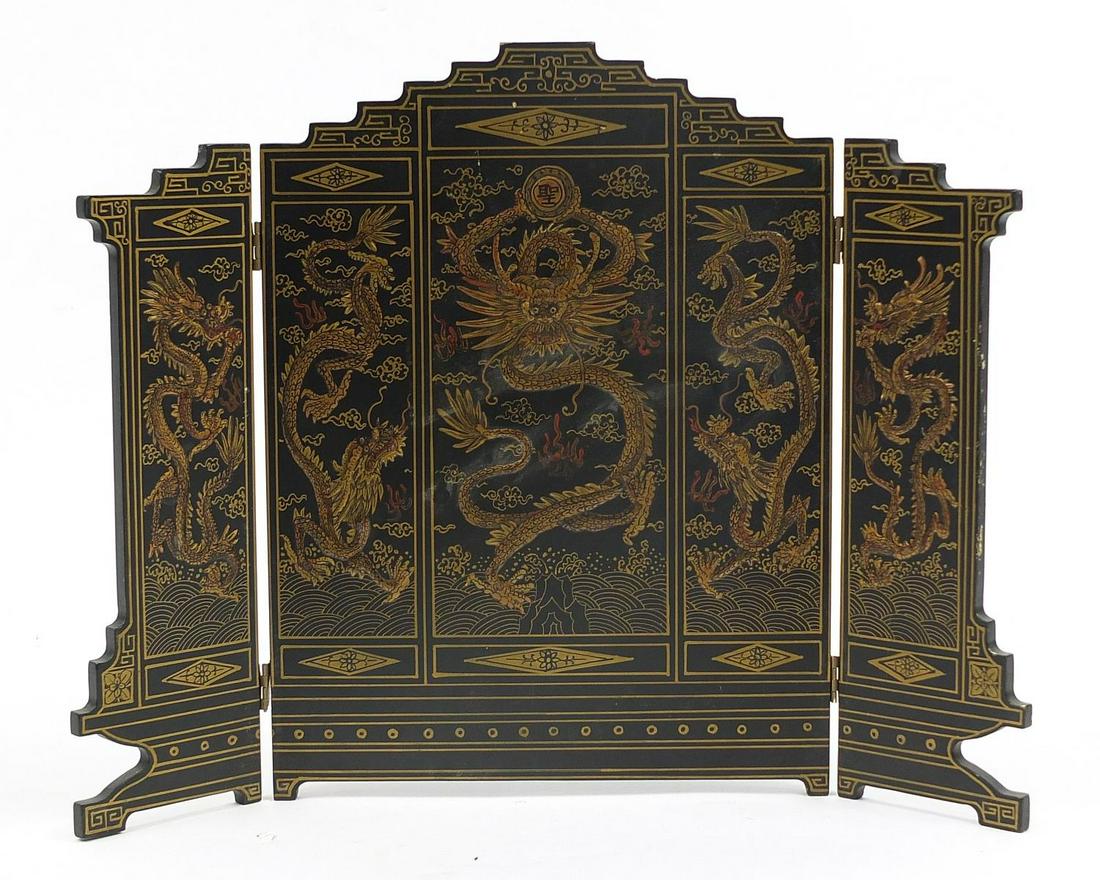 Chinese lacquered three fold table screen hand painted: Chinese lacquered three fold table screen hand painted and decorated in relief with dragons, calligraphy and red seal marks to the reverse, 41cm high x 54cm wide when open