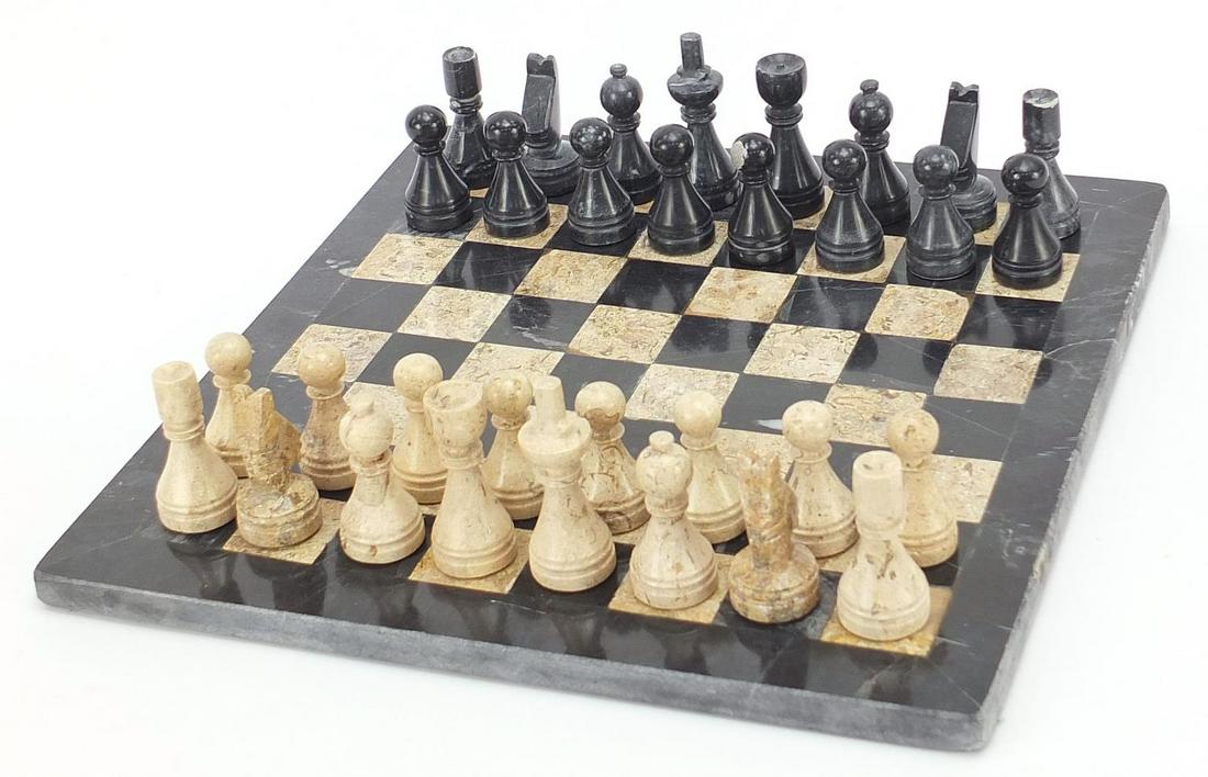 Carved stone chess set with inlaid marbl...: Carved stone chess set with inlaid marble board, the largest pieces each 6.5cm high, the board 30cm x 29.5cm