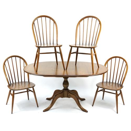 Ercol elm extending dining table and four stick back chairs, the table 73cm H x 110cm W x 96cm D,: Ercol elm extending dining table and four stick back chairs, the table 73cm H x 110cm W x 96cm D, the chairs each 90cm high