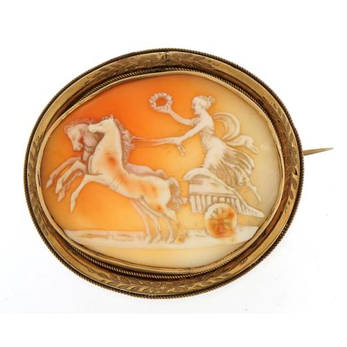 Large unmarked gold mounted cameo brooch carved with a Grecian female on a chariot housed in a: Large unmarked gold mounted cameo brooch carved with a Grecian female on a chariot housed in a tooled leather box, tests as 9ct gold, 5.4cm wide, 14.2g