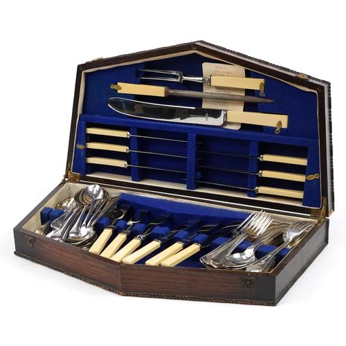 Thomas Turner Sheffield silver plated and stainless steel cutlery housed in an Art Deco oak canteen: Thomas Turner Sheffield silver plated and stainless steel cutlery housed in an Art Deco oak canteen with brass inlay, 51cm wide