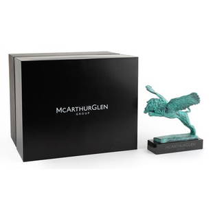 Mark Coreth for McArthur Glen Group, verdigris bronze study of a winged lion raised on a slate base: Mark Coreth for McArthur Glen Group, verdigris bronze study of a winged lion raised on a slate base with box, the figure 26cm wide