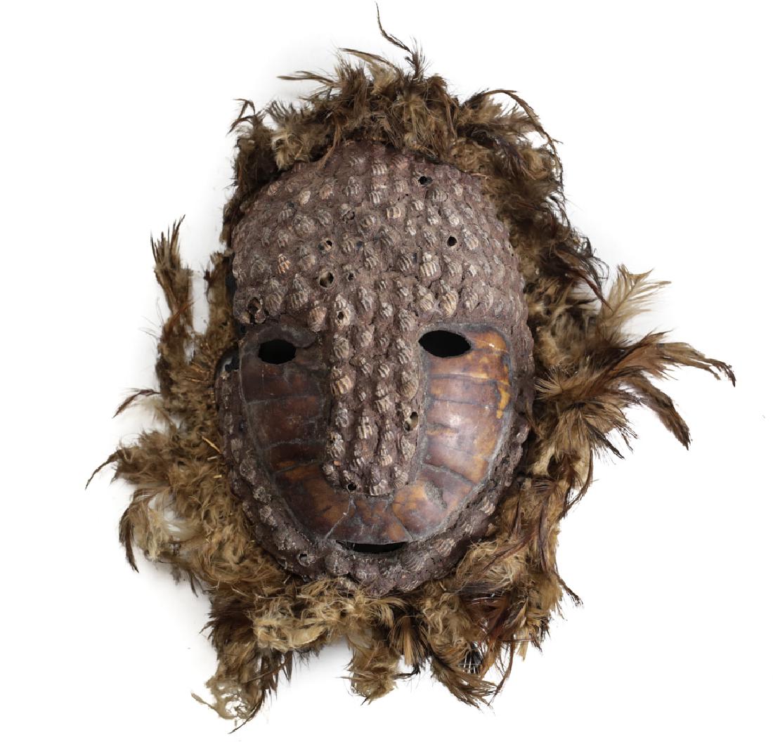 Mask Papua New Guinea, tortoise shell: Mask Papua New Guinea, tortoise shell, small seashells and feathers. 8" x 10" .5lbs. From the Estate of Dr. Gordon Saver, husband of Eunice Saver, an esteemed archaeologist of 35 years, known for her 