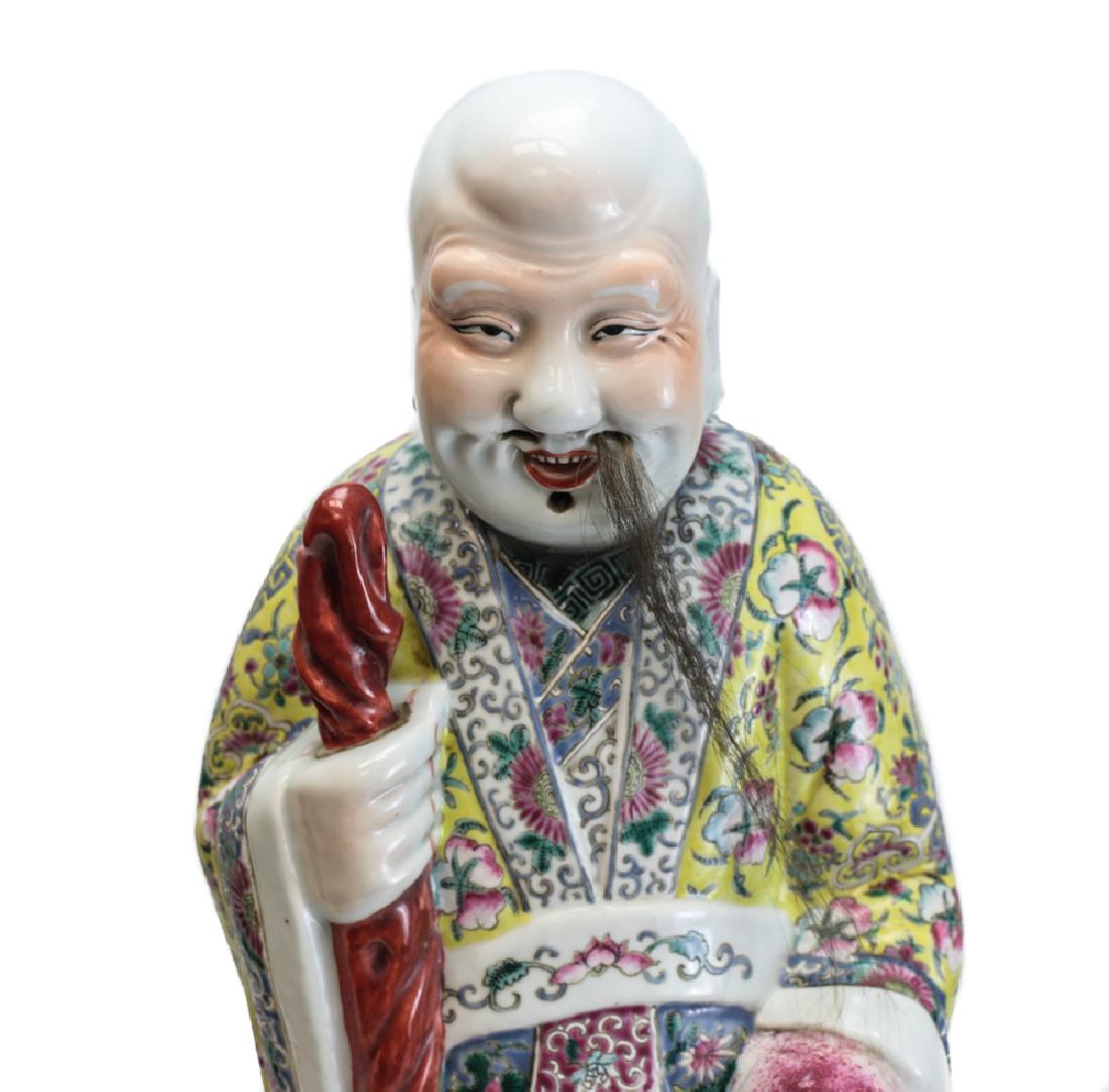 Chinese Porcelain Famille Rose Polychrome Enamel Statue: Chinese Porcelain Famille Rose Polychrome Enamel Statue, 24”, One of the three The Sanxing, the god Shouxing holds peach and staff. Floral designs on robe, with flying cranes on the back, Shou symbo