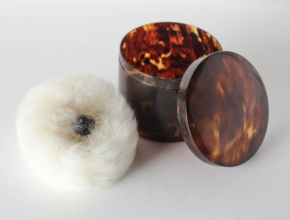 Tortoise Shell Powder Box: A well made tortoise Shell Powder Box with feather down puff. Cylindrical with gently domed lid. Puff has tortoise handle. Measures Approx., 3 in diameter x 2.5 in height.