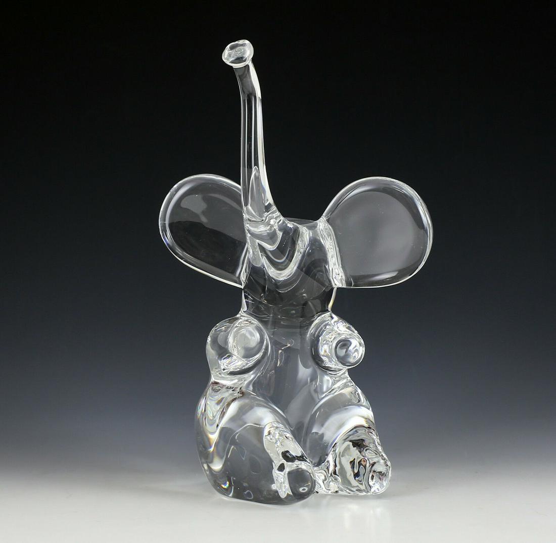 Daum France Art Glass Elephant, Seated Trunk Up.: Daum Art Glass Elephant, Seated Trunk Up. Charming, polished, clear, signed 'Daum France' on the side. 5.25lbs Approx. Measurements: 9.5" height x 6.5" Width.Domestic Shipping: $20