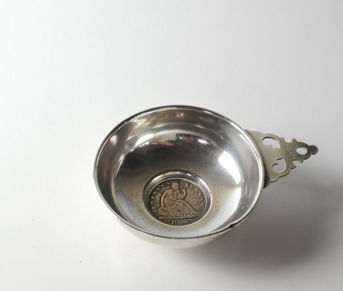 American Sterling Silver Tastevin Wine Tasting cup,: American Coin mounted Sterling Silver Tastevin Wine Tasting cup, with 1853 Half Dollar Coin. Marked Sterling Approx. Measurements: 52.37grams (1.683ozt) 3.125 in diameter; 4.25 length with handle x 1.