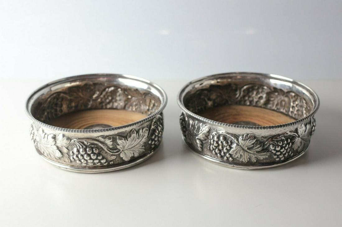 George III Pair of William Allen III 1800 London: George III Pair of William Allen III 1800 London Sterling Silver Wine Coasters, hand chased repousse grape and leaf motif. Wood insert. Hallmarks on bottom rim. Approx. Measurements: Gross weight 447.