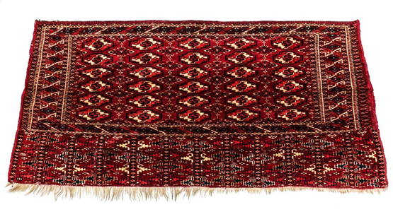 Antique c1900 Turkoman / Turkmen Tribal Rug: A c1900 Handknotted Turkoman / Turkmen rug woven in rows of guls on dark red ground with ivory detailing.Measures Approx: 54 inches x 27 inches