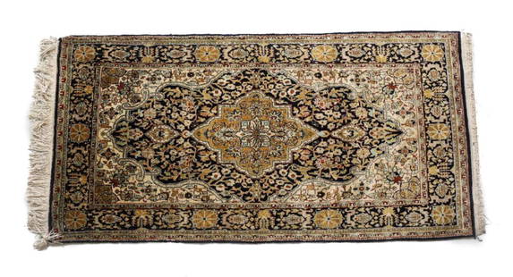 c1960 Persian Silk Qum Rug: A c1960 Handknotted Persian silk qum rug - Glossy pile in ocher, deep blue/black, tan, ivory, turquoise and red. Stylized floral design. Weight Approx., 7lbsMeasures Approx: 60.5inches x 30inches