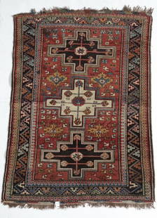 Antique Caucasian Rug, wool pile, geometric: A fine Antique Handknotted Caucasian Rug, wool pile, geometric shapes, stylized flowers, in blues, reds, ocher, green, off-white. Weight Approx., 4.5lbsMeasures Approx. 44inches w/out fringe x