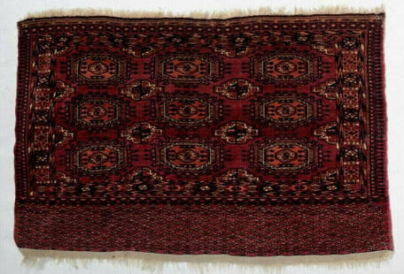 Antique Turkoman / Turkmen Rug: A fine Antique Handknotted Turkoman / Turkmen Rug, geometric patterns, wool pile, in reds, browns,blues, off-white. Weight Approx., 4lbsMeasures Approx. 47.25inches x 30.25inches w/out fringe