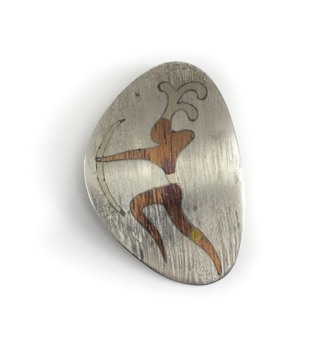 Taxco Metales Castillo Silver Mixed Metal Modernist Brooch c 1960. Amoeba form: Taxco Metales Castillo Silver Mixed Metal Modernist Brooch c 1960. Amoeba form features a warrior with bow and arrow. 16.76grams Approx. Measurements: 34mm x 49mm.Domestic Shipping: $