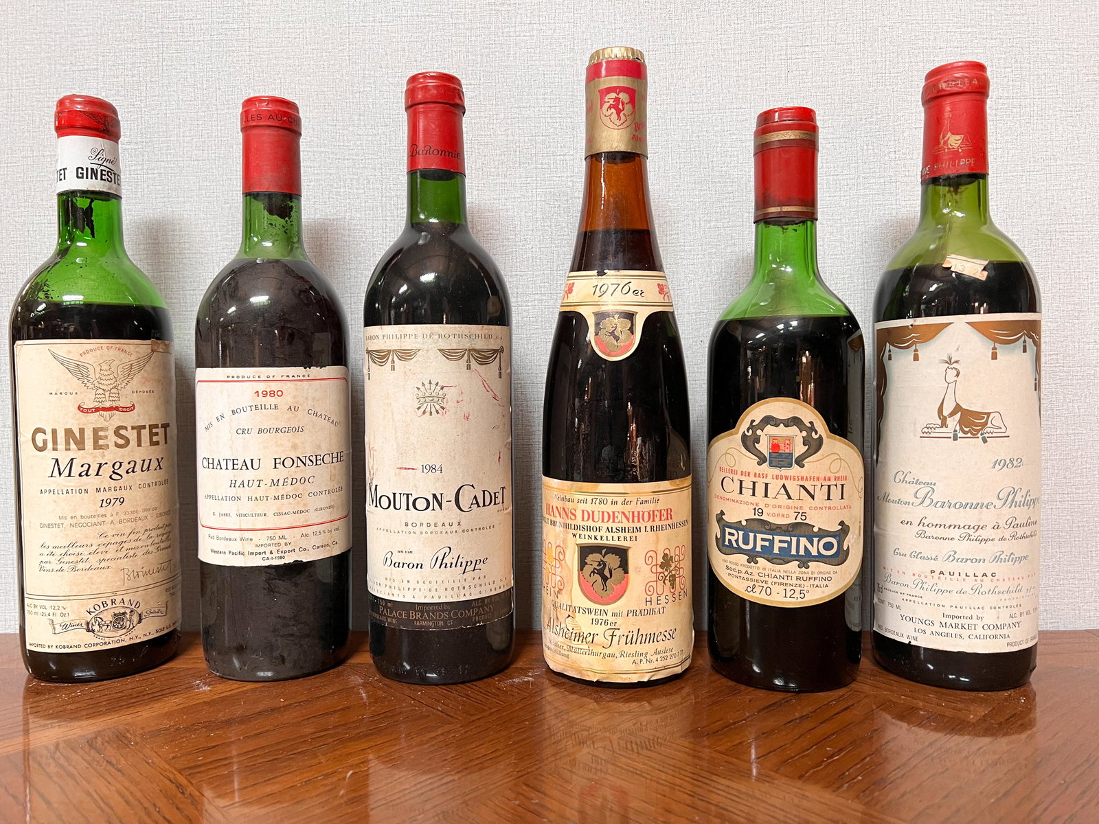 6 Vintage Estate Bottles of Wine Spirits Assorted: Ginestet Margaux 1979; Chateau Fonseche 1980; Baron Philippe Mouton Cadet 1983; Hanns Dudenhofer 1976; Ruffino 1975; Chateau Mouton Baronne Philippe Rothschild 1982 Domestic Shipping: Please Inquire