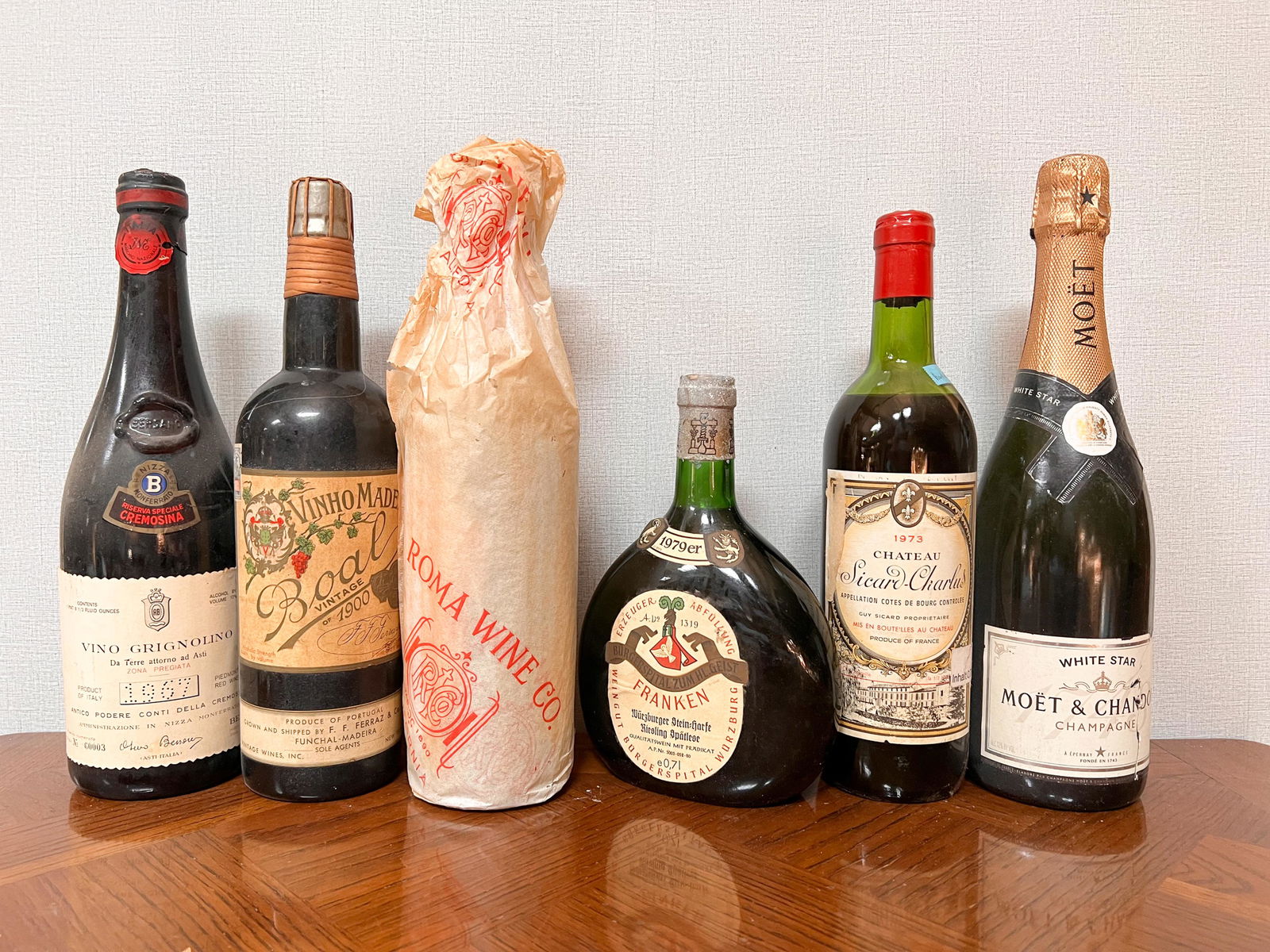 6 Vintage Estate Bottles of Wine Spirits Assorted: Vino Grignolino 1967; Vinho Made Boal 1900; Roma Wine 1935 in wraps; Weingut Burgerspital Wurzburg Franken 1979; Chateau Sicard Charlus 1973; Moet & Chandon Champagne Domestic Shipping: Please Inquire