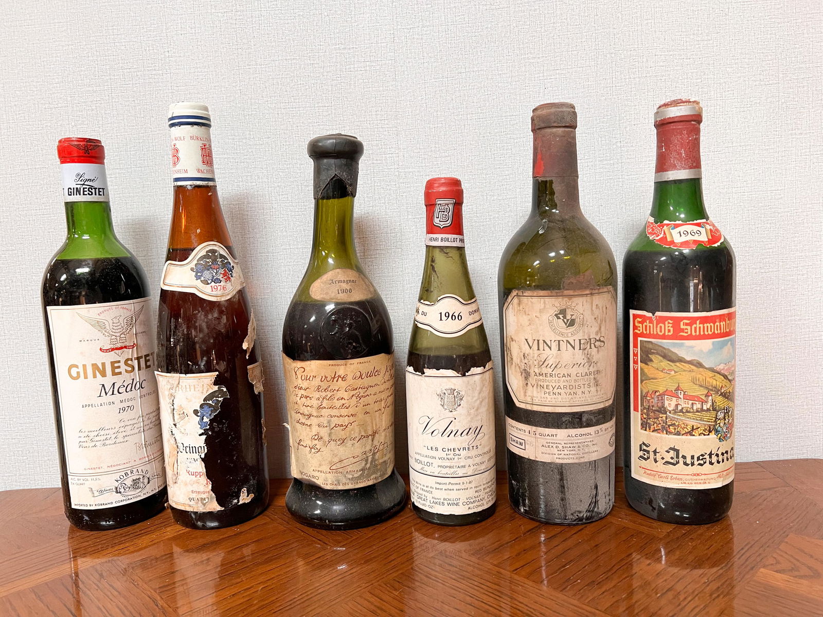 6 Vintage Estate Bottles of Wine Spirits Assorted: Ginestet Medoc 1970; German Wine partial label 1976; Robert Castagnon Armagnac 1900; Volnay 1966; Vitners Superior; St Justina 1969 Domestic Shipping: Please Inquire