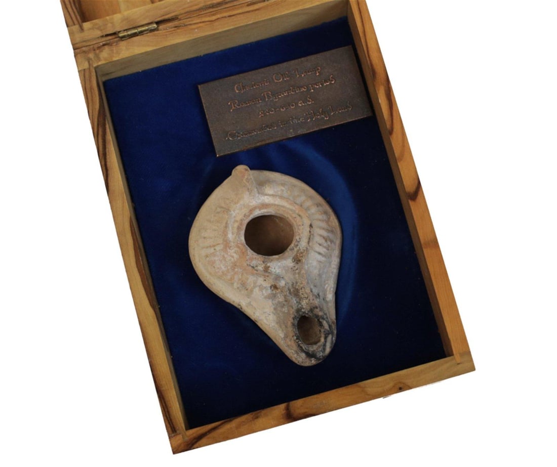 Byzantine Holy Land Terracotta Oil Lamp: Byzantine Holy Land Terracotta Oil Lamp, in olive wood presentation box. 200-600 AD lamp. Measures Approx., 3.25in. x 2.25in.. Total weight with box 1lb Domestic Shipping: $30
