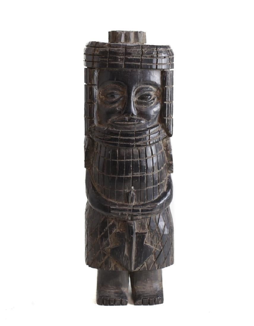 African Carved Wood Standing Guardian Figure: African Carved Wood Standing Guardian Figure, Appears to be carved wearing a type of armor, and holding a staff or weapon. 4lbs. Approx. 10.5 inches height x 3.5 in. x 3 in.